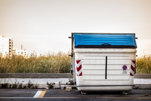 Builders performing waste clearance at a High Wycombe construction site