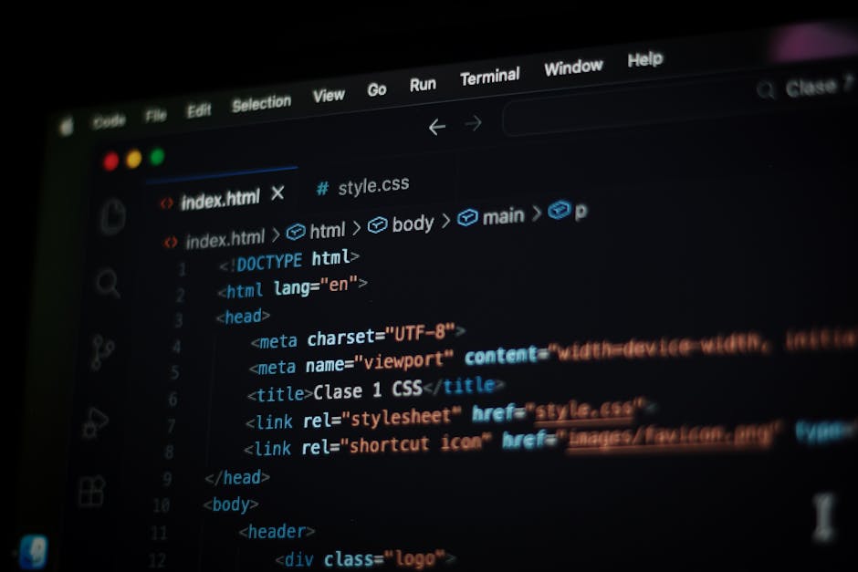 Close-up view of a computer screen displaying lines of HTML and coding syntax in multiple colors, including blue, yellow, green, and red. The code features tags such as <div>, <h1>, and <img>, with im